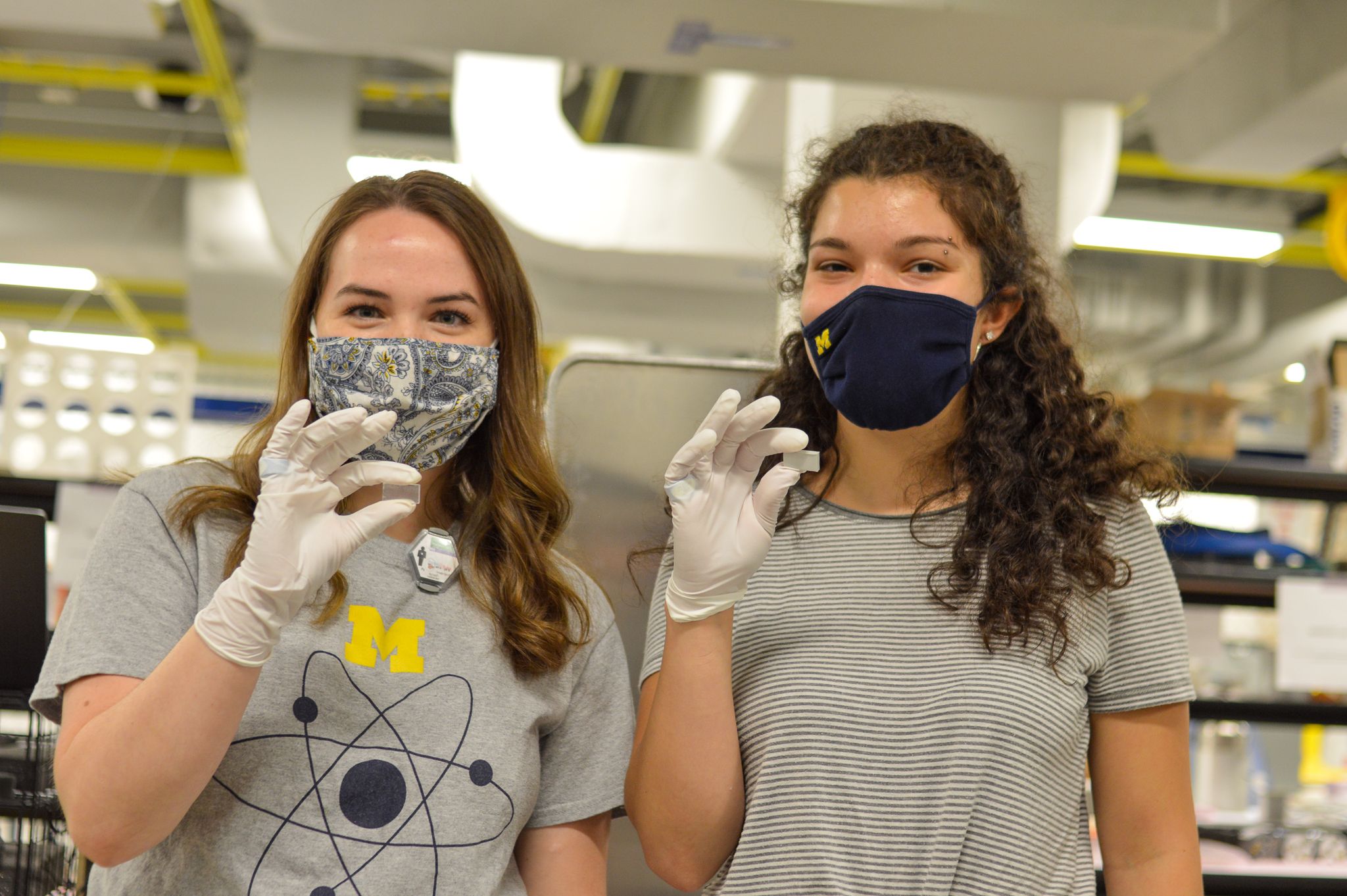 PhD student, Leah, and undergraduate student, Tessa, working together to characterize new organic scintillators made of organic glass.